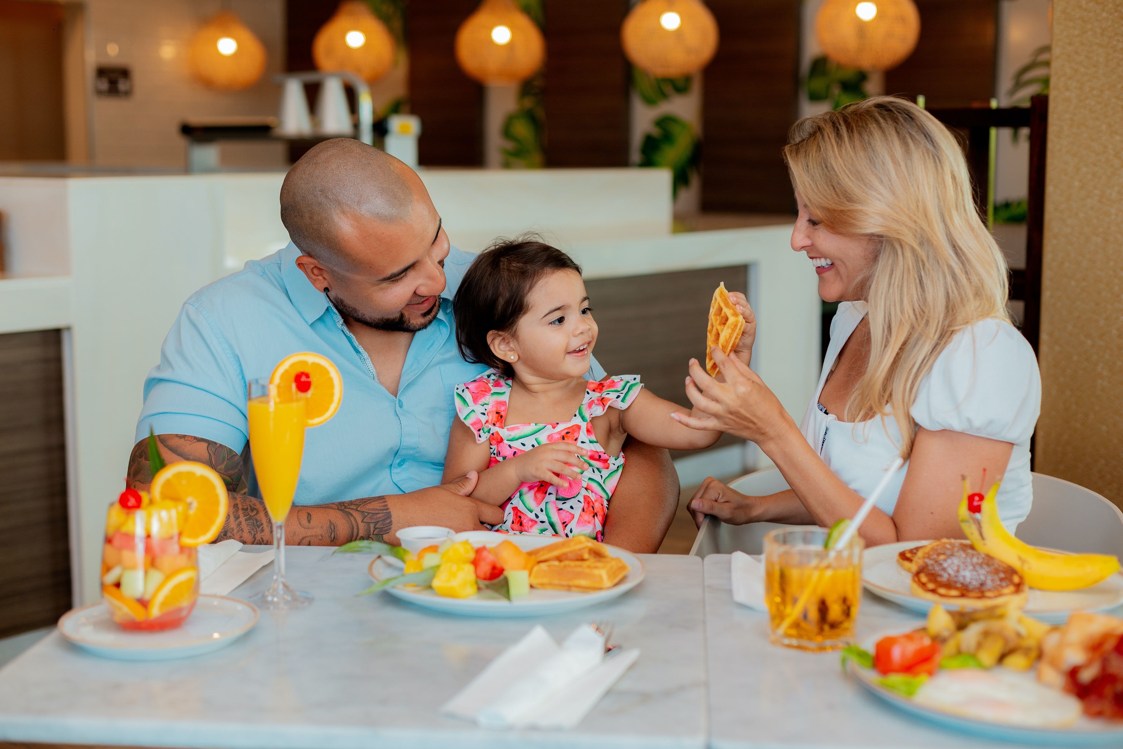 bug free family at table eating breakfast 